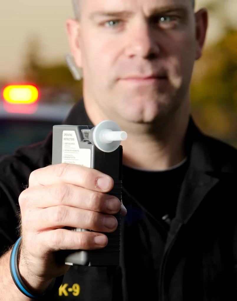 officer holding breathalyzer